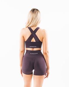 HIGHLIGHTS. Removable cups. Scrunch detailing in the center. Medium to high impact. Moisture-wicking, breathable fabric. Unbelievably soft texture. Knitted Alphalete core wordmark Seamless construction. Reinforced binding arm and neckline finishing FIT SUGGESTION. This item runs true to Alphalete's standard seamless fit.. If you are between sizes, we recommend sizing up.. Model is 5’7”/170cm, wearing a size XS with a 33.5”/85cm bust.. MATERIALS AND WASHING DIRECTIONS. 51% Polyamide, 38% Polyeste Purple Nylon Activewear For Workout, Purple Compression Seamless Activewear, Purple Nylon Yoga Activewear, Purple Nylon Activewear For Gym, Compressive Purple Sports Bra, Purple Compressive Moisture-wicking Sports Bra, Purple Compressive Sports Bra, Compressive Sporty Purple Sports Bra, Breathable Purple Nylon Activewear