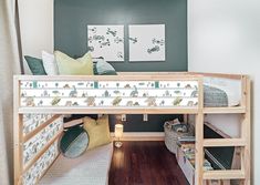 a bunk bed with wooden stairs and green walls