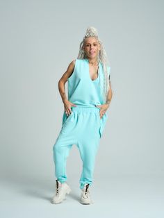 Enhance your off-duty style with our vibrant activewear look. Wear it as a set or mix and match the color-popping pieces with your casual basics. FEATURES: A 2-piece sweatsuit set featuring a V-neck sleeveless top and sweatpants with pockets. 100% Handmade. SIZE & FIT: Fit: A relaxed fit with room to move The model is wearing size Small or S/M View our SIZE CHART before ordering MATERIALS & CARE: Content: 65% Cotton, 35% Polyester Care: Machine wash on cold (30ºC) with a mild detergent. Clothes Trendy Spring Workout Sweatpants, Sporty Relaxed Fit Sets For Spring, Spring Athleisure Sets With Relaxed Fit, Solid Color Athleisure Sets For Spring, Solid Athleisure Sets For Spring, Relaxed Fit Tracksuit For Sports In Spring, Trendy Tracksuit For Loungewear In Spring, Trendy Tracksuit For Spring Loungewear, Trendy Spring Tracksuit For Loungewear