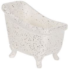 a white bath tub with black speckles on the top and legs, against a white background