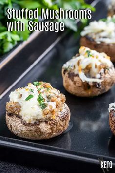 stuffed mushrooms with sausage and cheese on a baking sheet in front of some parsley