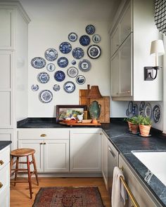 a white kitchen with blue and white plates on the wall