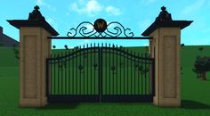 an iron gate in front of a grassy field