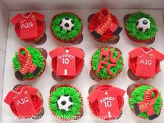 the cupcakes are decorated in red and green icing with soccer gear on them