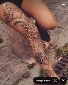 a woman's leg with an intricate tattoo on her arm and the words image search below it