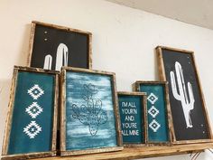 three framed art pieces on a shelf with cactus and wall hangings above them that say mail your and you're welcome