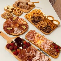 a table topped with lots of different types of food and desserts next to each other