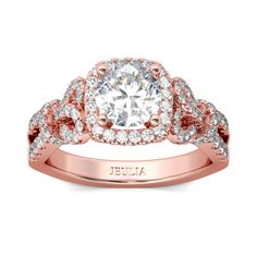 This spectacular engagement ring is the marriage of contemporary and vintage-inspired design. Crafted in fine rose-gold tone,it features a sparkling round cut stone at the center wrapped in a shimmering halo frame.While additional sparking stones decorate the ring's impressive bowknot shank. Glamorous and classic, this exceptional ring will forever express your eternal love and undying commitment.Carat Weight: 2.5 ctStone Size: 7 mmStone Type: Jeulia® StoneNumber of Stones: 1 Stone Color: Diamond WhiteStone Shape: RoundCarat Weight: 1.893 ctStone Size: 1,1.2,1.5 mmStone Type: Jeulia® StoneNumber of Stones: 118 Stone Color: Diamond WhiteStone Shape: RoundWeight: 5.5 gWidth: 9.11 mmHeight: 8.53 mmThickness: 2.52 mmMaterial: 925 SilverPlating Color: Rose Gold Rose Gold Round Cut Halo Ring, Rose Gold Halo Ring With Round Cut, Formal Rose Gold Halo Ring, Rose Gold Round Cut Halo Diamond Ring, Rose Gold Halo Ring For Anniversary, Rose Gold Halo Wedding Ring, Wedding Rose Gold Halo Ring, Anniversary Rose Gold Halo Ring, Rose Gold Diamond Ring With Halo Setting