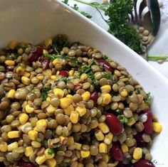 a white bowl filled with corn and vegetables