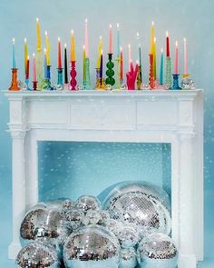 disco balls and candles on a fireplace mantel