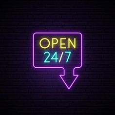 neon open sign with arrow on brick wall