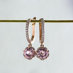 Whimsical yet elegant, Hanaka features a pair of blush-pink Rosé sapphires cut in the shape of an open blossom and framed by petals of glistening moissanites. In the drop style, the blooms dangle delicately from studded huggie hoops, adding a touch of elegance to the delightful spirit of spring. Made to order. Please allow 6-8 weeks for delivery. DETAILS: Gemstone: Type: Sapphire (cultured) Size: 6 mm (each) Color: Rosé Pink Cut: Blossom Design: Style: Drop Accents: Round Brilliant Moissanites B Rosé Pink, Blossom Design, 8 Weeks, Design Style, Round Brilliant, Pandora Charm Bracelet, Pink Rose, Pink Roses, Blush Pink