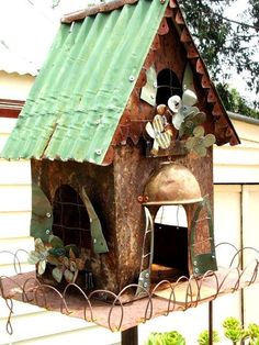 a bird house with flowers on the roof