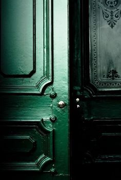 a green door with ornate designs on it