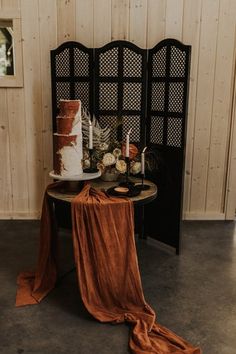 a table topped with a cake and two candles