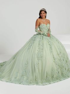 Look jaw dropping in this dramatic House of Wu 26070 for your quinceneara or prom! Enchanting in a ballgown silhouette, this number is embellished with dainty 3d floral appliques forming leafy foliage on a sheer overlay. The detailed bodice offers a cinched waist and a strapless sweetheart neckline, while the dramatic skirt flows into a long chapel train. This glittering House of Wu 26070 creation is perfect for a standout style and flawless fit. Models are wearing Ivory/Champagne, and Meadow colors. Style: howu_26070 Fabric: Lace/Tulle Details: Strapless, Detachable sleeves, Floral applique, Glitters, Voluminous, Mid back, Lace-up tie, Floor length, Sweep train Length: Long Neckline: Sweetheart Waistline: Natural Silhouette: Ballgown Please refer to our returns and exchanges policy page ( Dramatic Skirt, Green Ball Gown, Sheer Gloves, Quinceanera Collection, Debutante Ball, Tulle Balls, Fit Models