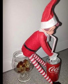 an elf is pouring coke into a can