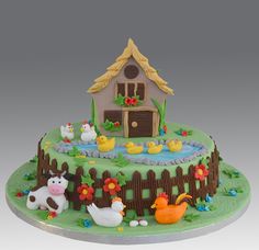 a cake decorated with farm animals and ducks