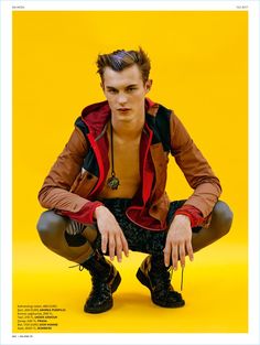 a young man sitting on top of a yellow floor