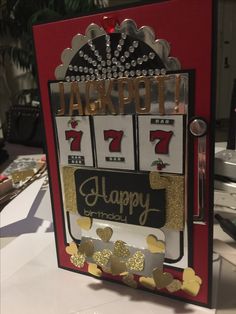 a slot machine with gold hearts on it and the words happy birthday next to it