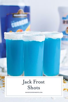 three glasses filled with blue jello sitting on top of a counter next to a can of jack frosty shots