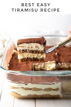 someone cutting into a layered dessert in a glass dish