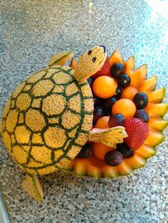 a turtle made out of fruit sitting on top of a counter