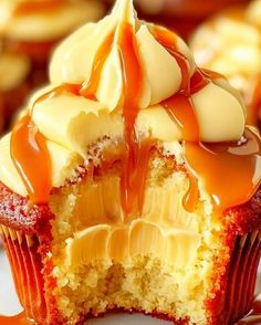 a cupcake with caramel sauce drizzled over it's icing