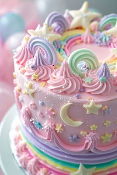 there is a pink cake with stars and swirls on it's icing