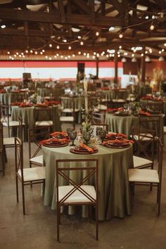 tables set up for an event with green linens