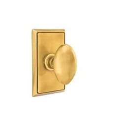 a brass plated door handle with an oval knob