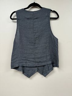 Upgrade your wardrobe with our Italian Linen Vest/Top. Made from luxurious Italian linen, this versatile piece can be worn as a top or a vest, perfect for any occasion. Its front button closure and v neck cut add a touch of elegance, while the two front pockets provide functionality. Experience the perfect balance of fun, elegance, and comfort. Pair it with anything for a sophisticated look. Linen Sleeveless Vest For Layering, Sleeveless Linen Tops For Fall, Spring Linen Vest For Layering, Spring Layering Linen Vest, Elegant V-neck Tops With Pockets, Elegant V-neck Top With Pockets, Linen V-neck Top For Layering, Linen Vest, Scarf Belt