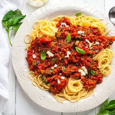 a white plate topped with spaghetti and sauce