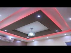 a room that has some lights on the ceiling and is lit up with red light