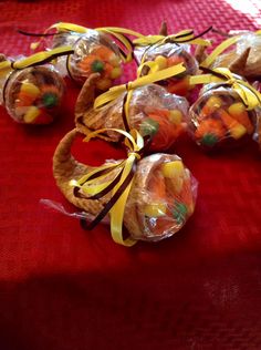 candy wrapped in cellophane and tied with yellow ribbons on a red tablecloth