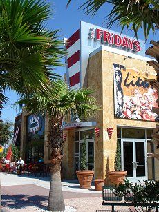 the front of a restaurant with palm trees in front of it and a sign that says friday's