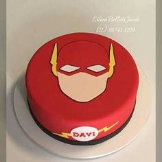 a red cake decorated with the flash logo