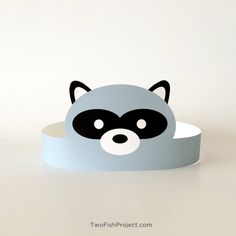 a raccoon headband is shown on a white surface with black and gray accents