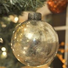 an ornament hanging from a christmas tree in front of a decorated holiday tree