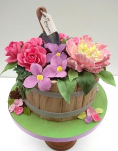 a wooden basket filled with flowers on top of a table