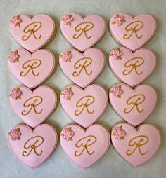 pink heart cookies with gold monogrammed initials and flowers in the shape of hearts