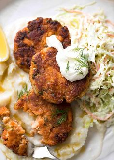 crab cakes, mashed potatoes and coleslaw on a plate