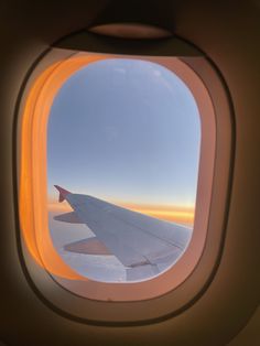 an airplane window looking out at the sky