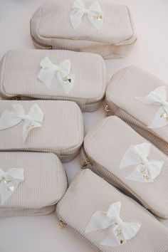 six pieces of white fabric with bows on the top and bottom, sitting next to each other