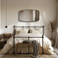 a bed with white sheets and pillows in a bedroom next to a mirror on the wall