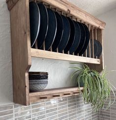 a potted plant sitting on top of a wooden shelf filled with plates and pans