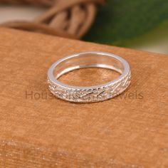 a silver ring sitting on top of a wooden table