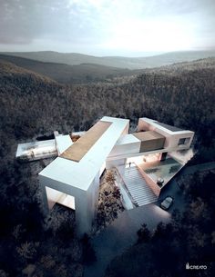 an aerial view of a house in the middle of a forest with trees around it