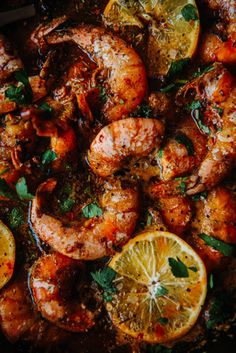 shrimp with lemons and herbs in a skillet