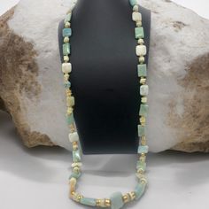 Immerse yourself in the enchanting allure of the sea with this exquisite 18" minimalist mystic mermaid necklace! 💎 Meticulously handcrafted with vibrant jade beads, shimmering gold accents, and mesmerizing aquamarine stones, this piece exudes oceanic elegance and natural beauty. Each bead and gemstone has been carefully selected and strung together to create a harmonious blend of colors that evoke the depths of the ocean. The minimalist design allows the stunning materials to take center stage, making this necklace a true statement piece. Whether you're a mermaid at heart or simply appreciate unique and meaningful jewelry, this necklace is sure to captivate. Wear it to embrace the allure of the sea or as a reminder of the beauty that lies beneath the waves. 🌊 ✨Elevate your jewelry collec Spiritual Aquamarine Gemstone Necklace, Turquoise Amazonite Beaded Necklace, Handmade Spiritual Aquamarine Necklace, Single Strand Aquamarine Jewelry Gift, Amazonite Gemstone Beaded Jewelry, Spiritual Turquoise Amazonite Gemstone Beads Necklace, Elegant Turquoise Agate Beaded Necklaces, Spiritual Turquoise Amazonite Necklace With Gemstone Beads, Spiritual Single Strand Amazonite Jewelry